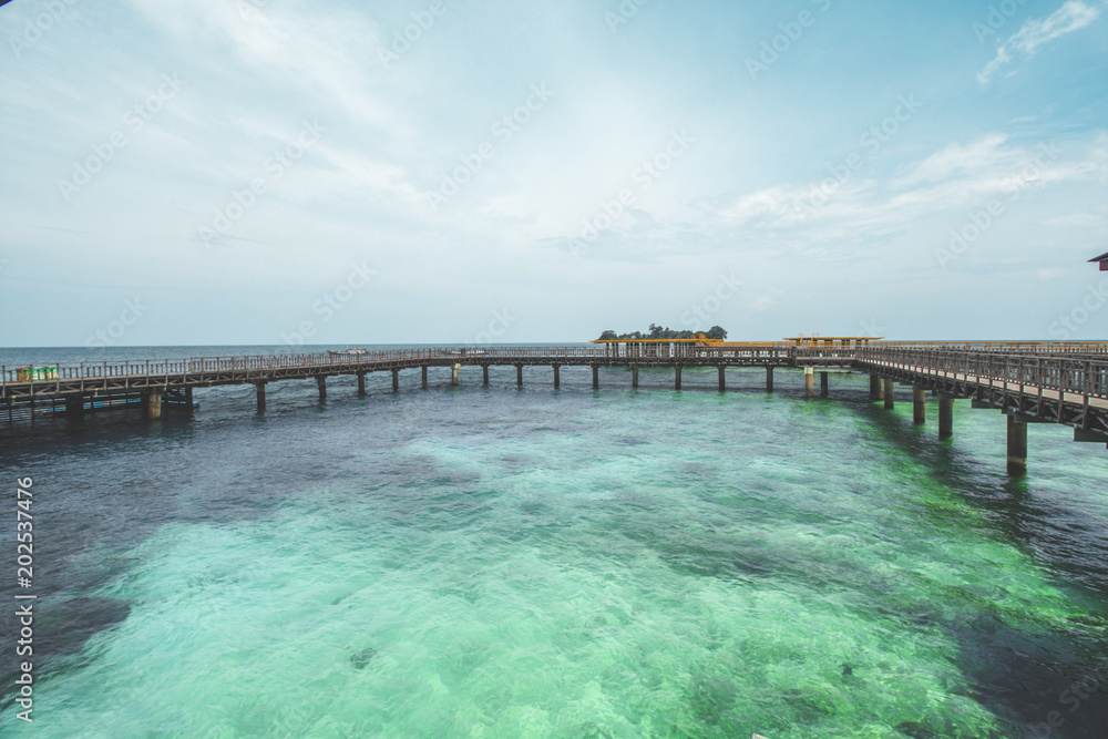 Wooden Pier and Clear Sea Water at Tropical Beach