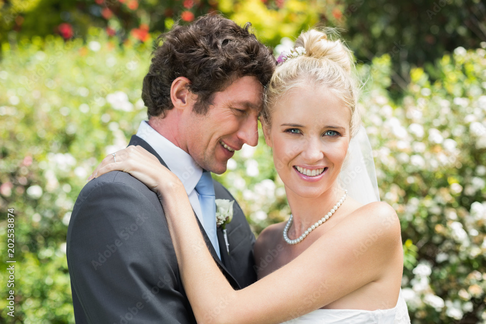 Romantic smiling newlyweds hugging each other Romantic smiling newlyweds hugging each other