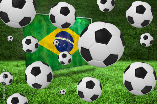 Black and white footballs against brazil flag in grunge effect