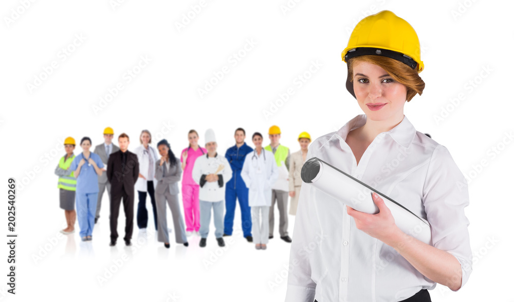 Composite image of pretty young architect smiling at camera against group of workers Composite image of pretty young architect smiling at camera against group of workers