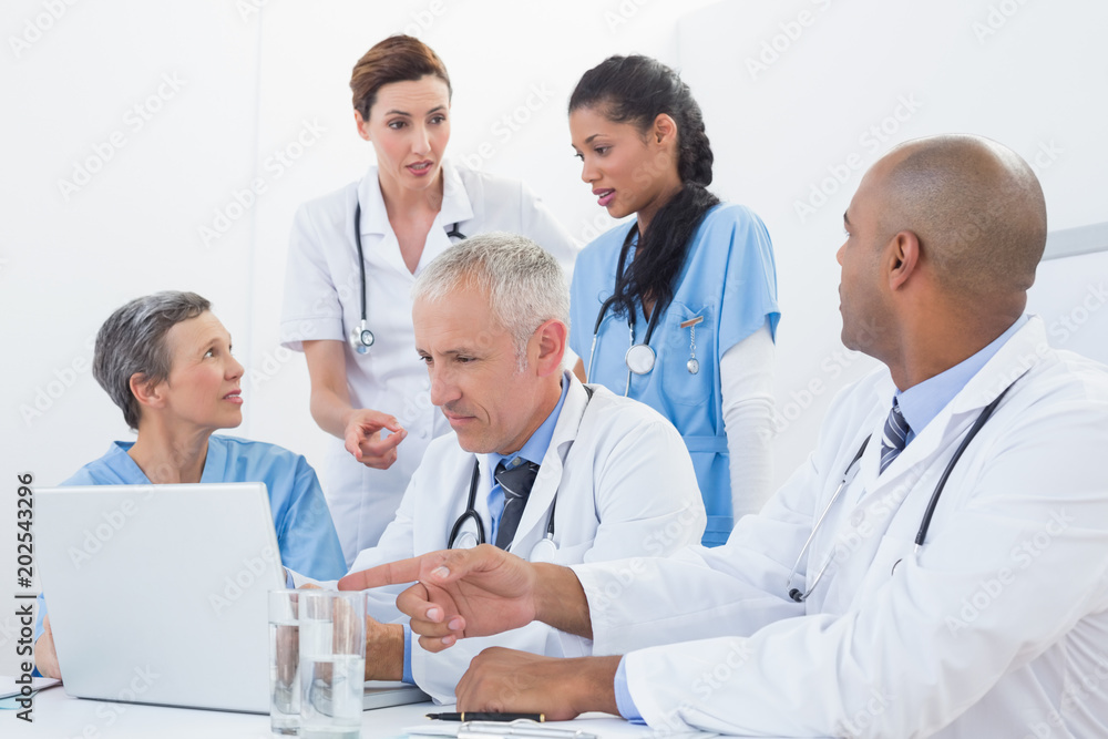 Team of doctors working on laptop Team of doctors working on laptop