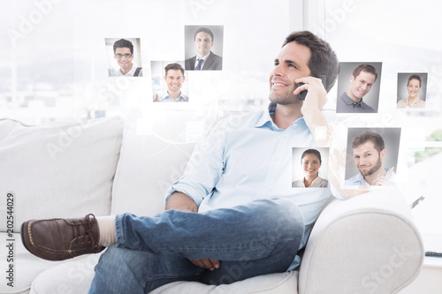 Cheerful man sitting on the couch making a phone call against profile pictures © vectorfusionart