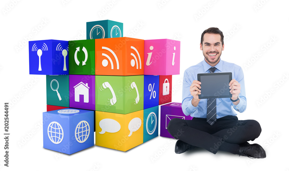 Smiling businessman showing his digital tablet against app cube Smiling businessman showing his digital tablet against app cube