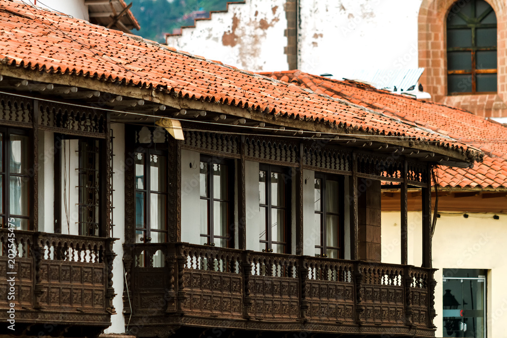 Wrought wood balconies and tiles eaves in front of the main square of Cusco (Peru) Wrought wood balconies and tiles eaves in front of the main square of Cusco (Peru)