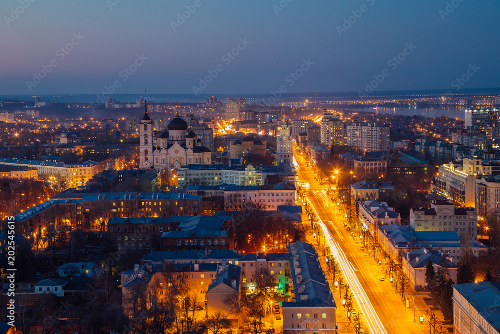 Night Voronezh downtown. Aerial view from skyscraper roof height to Revolution prospect - central street of Voronezh - obrazy, fototapety, plakaty 