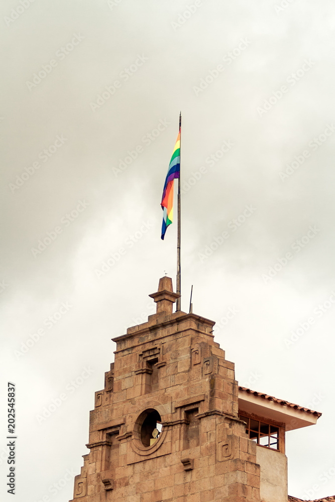 Colorful flag of Cusco (Peru) on top of City Hall of that city