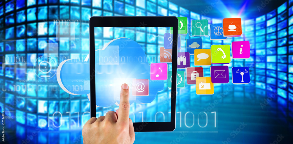 Hand using tablet pc against composite image of cloud with apps Hand using tablet pc against composite image of cloud with apps