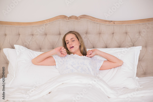Natural tired woman yawning and resting in bed © WavebreakmediaMicro