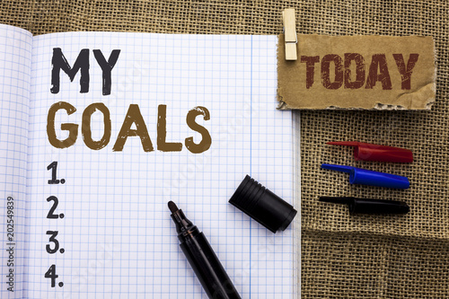 Text sign showing My Goals. Conceptual photo Goal Aim Strategy Determination Career Plan Objective Target Vision written on Notebook Book With Marker on the jute background Today. photo