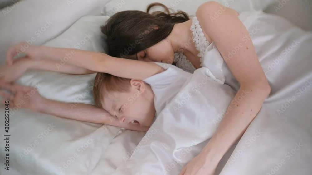 Mom and son wake up together. Mom and son wake up together.