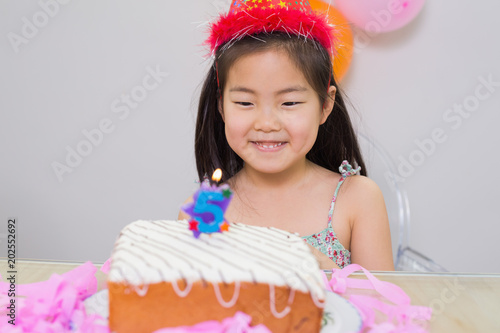 Cute little girl looking at her birthday party