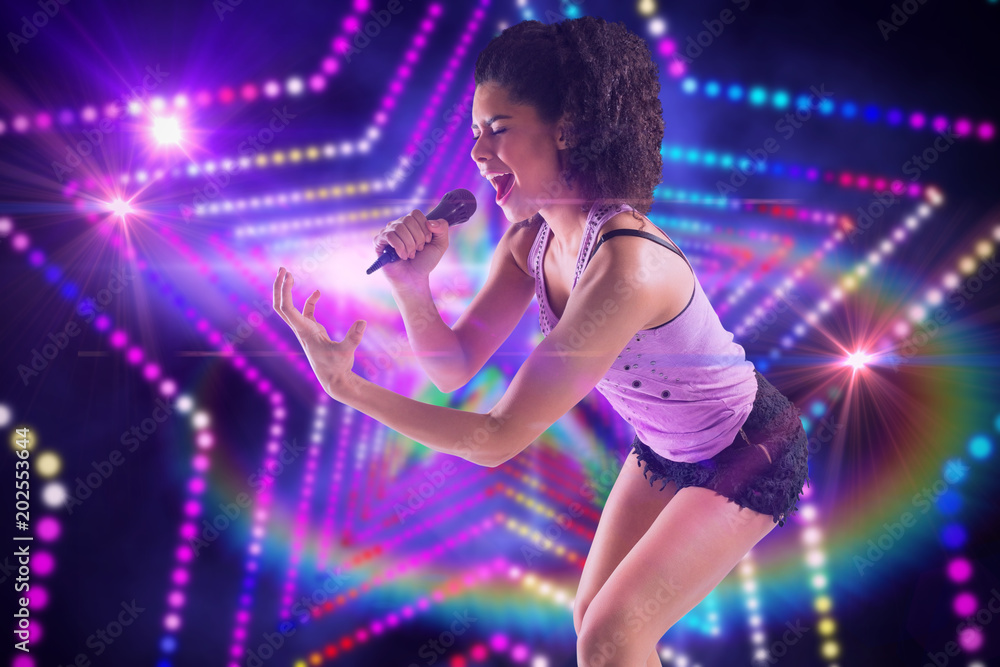 Pretty girl singing against digitally generated star laser background Pretty girl singing against digitally generated star laser background