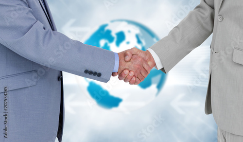 Side view of shaking hands against global business graphic in blue