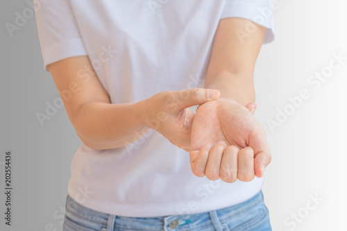 Woman scratching her wrist.