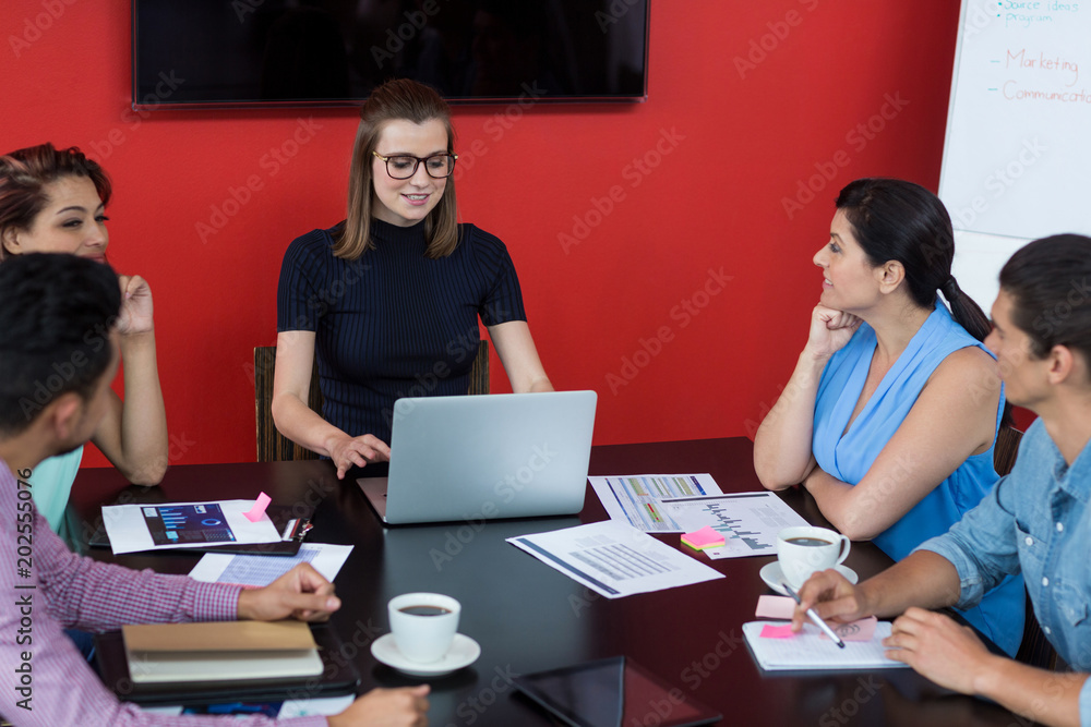 Business executives discussing during meeting Business executives discussing during meeting