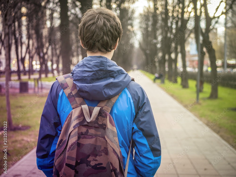 young male teenager schoolboy in the city with backpack young male teenager schoolboy in the city with backpack