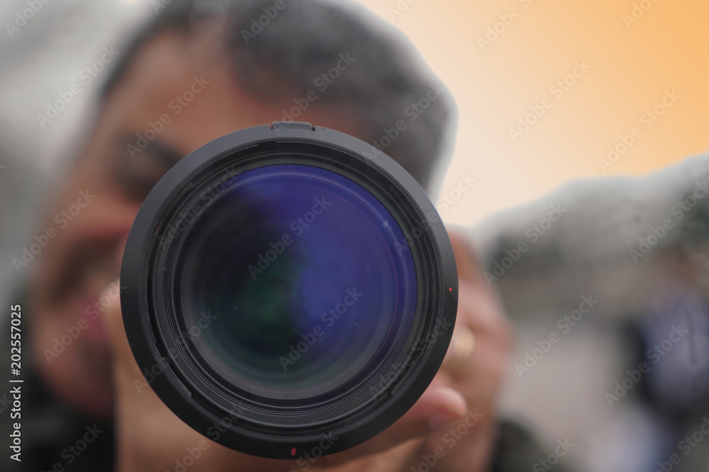 Blurred image of a smiling man looks into the camera's viewfinde Blurred image of a smiling man looks into the camera's viewfinde