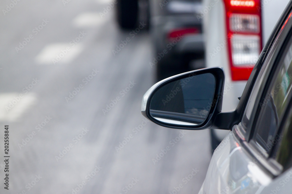 Mirror side of cars on the road heading towards the goal of the trip. tourism And Race car. Mirror side of cars on the road heading towards the goal of the trip. tourism And Race car.
