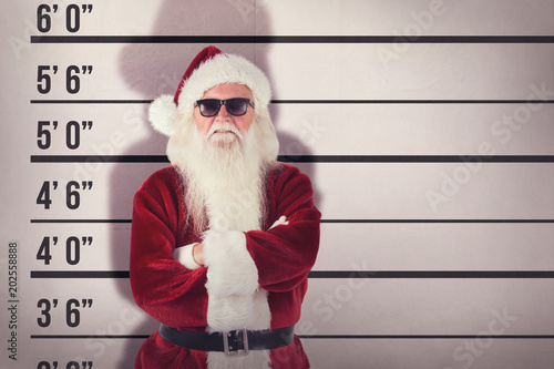 Santa Claus wears black sunglasses  against mug shot background