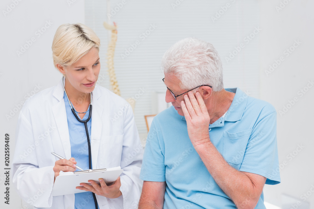 Doctor explaining prescription to senior patient Doctor explaining prescription to senior patient