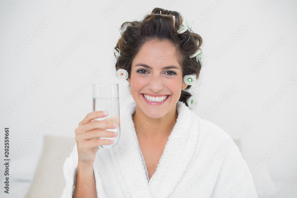 Smiling natural brunette holding glass of water Smiling natural brunette holding glass of water
