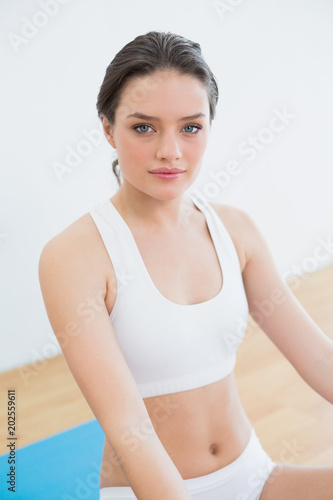 Toned brunette sitting at fitness studio © WavebreakmediaMicro