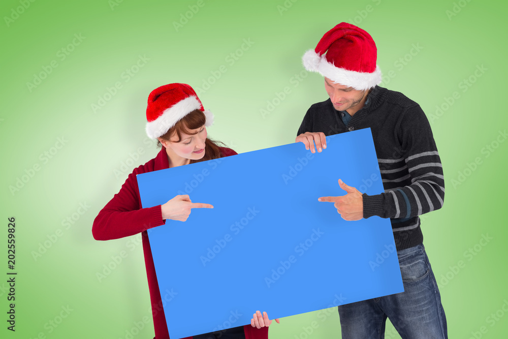 Couple holding a white sign against green vignette Couple holding a white sign against green vignette