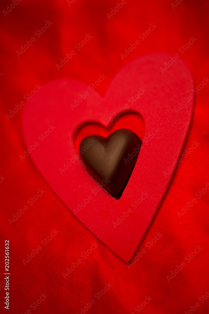 Chocolate love heart and red paper heart 