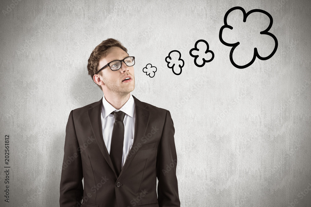 Young businessman thinking and looking up against white background Young businessman thinking and looking up against white background