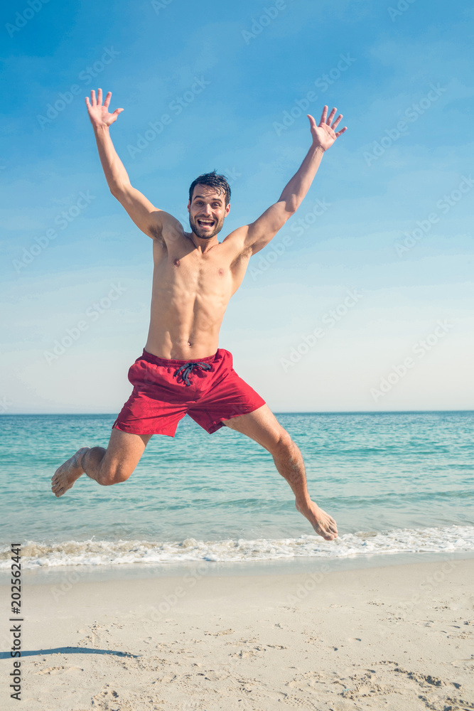 Happy man jumping on the beach Happy man jumping on the beach