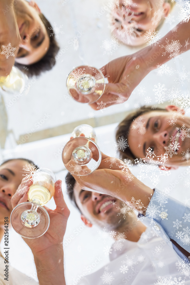 Φωτογραφία Casual business team toasting with champagne against snow falling