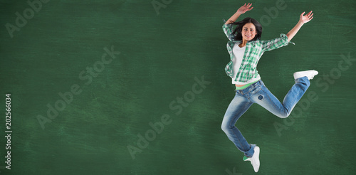 Принти на полотні Happy brunette against green chalkboard