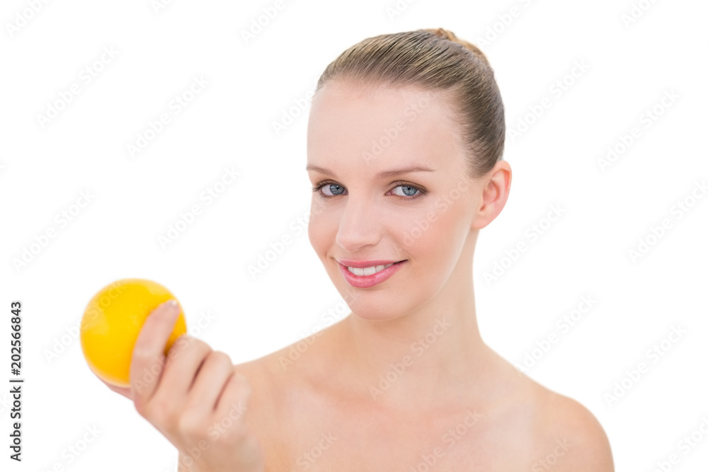 Joyful pretty blonde model holding an orange Joyful pretty blonde model holding an orange