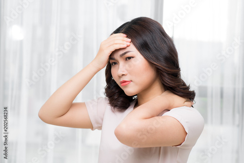 Tired woman having pain in neck
