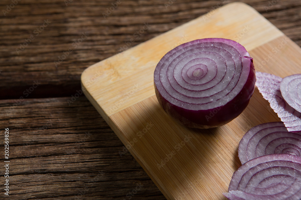 Sliced onions on chopping board Sliced onions on chopping board