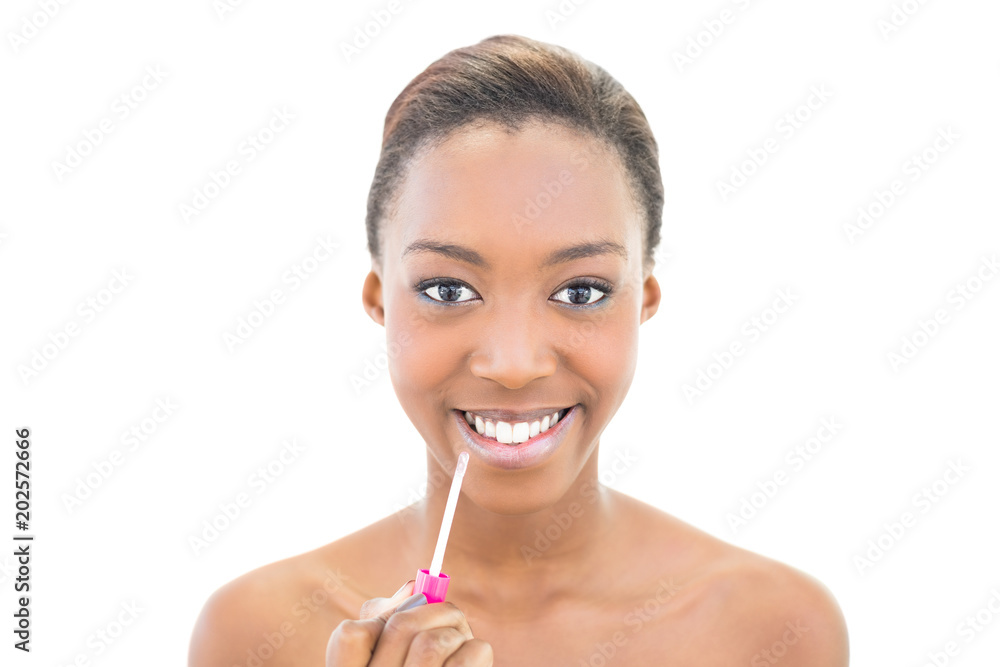 Cheerful natural beauty using lip gloss Cheerful natural beauty using lip gloss