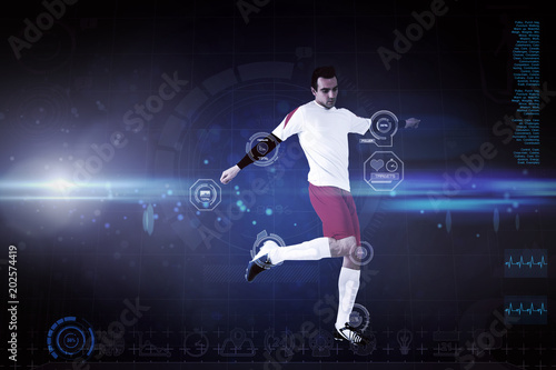 Football player in white kicking against blue dots on black background © vectorfusionart