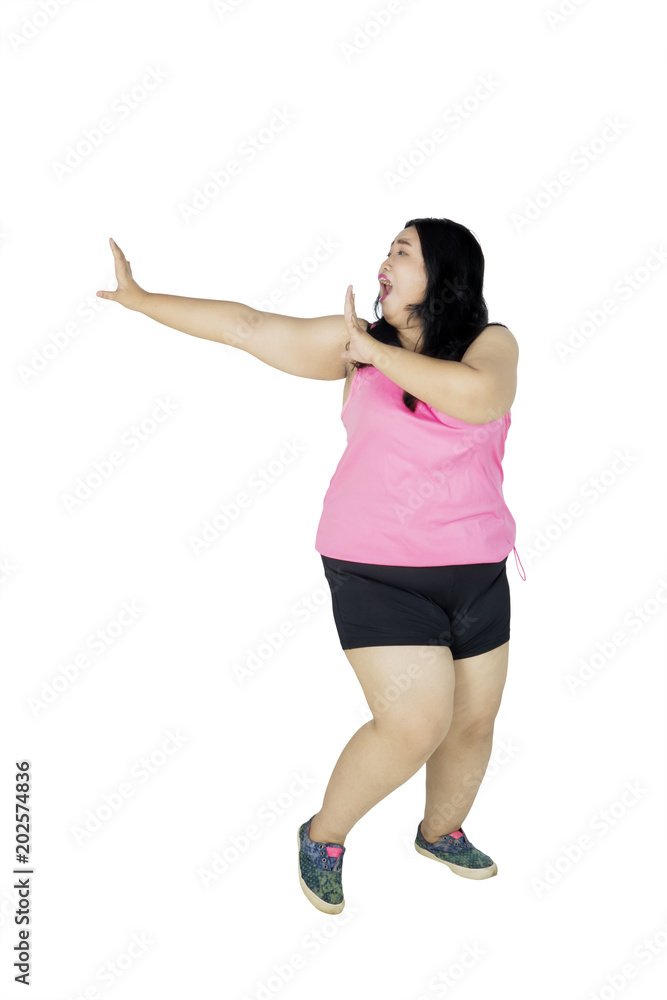 Overweight woman running with fear expression