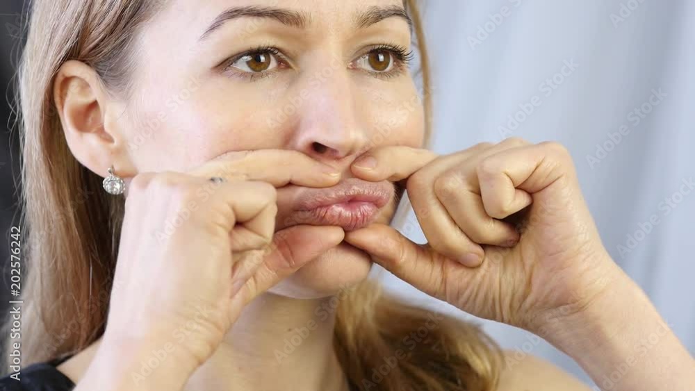 prevention of skin aging, woman performs exercises for a face building. strengthening the muscles around the lips prevention of skin aging, woman performs exercises for a face building. strengthening the muscles around the lips