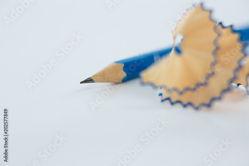 Close-up of blue pencil shavings with pencils