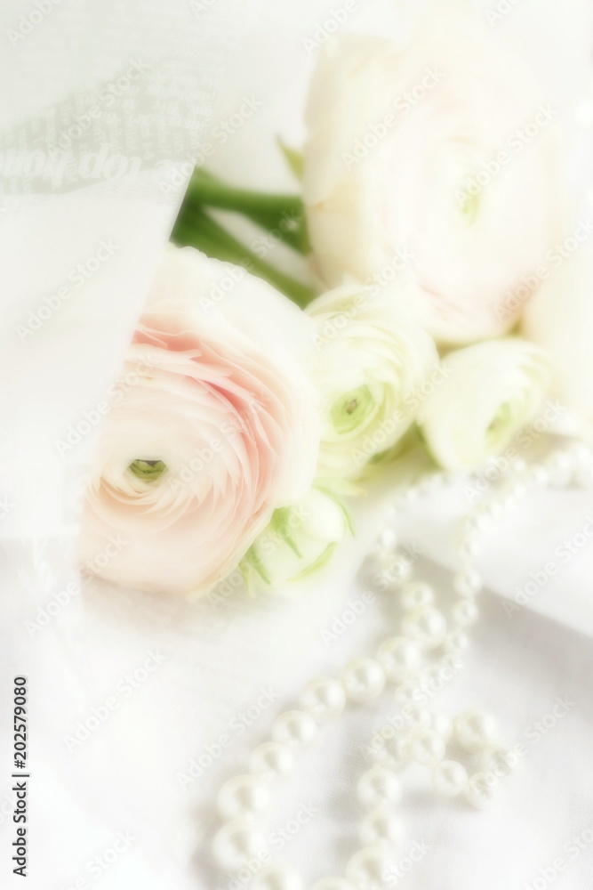Blur effect, soft focus flowers background with bouquet of pale pink  ranunculus on white linen background .Beautiful Holiday background.copy space.