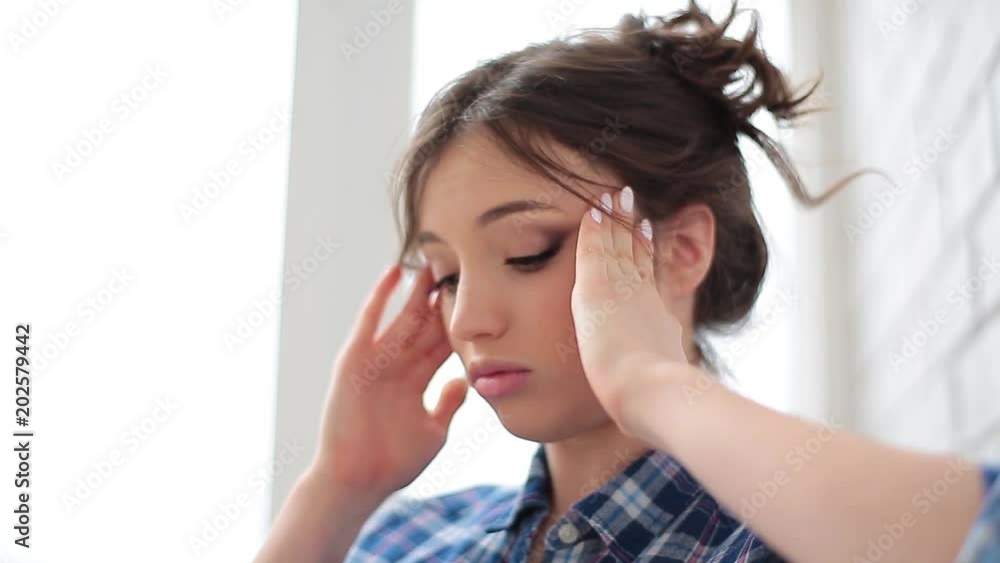 young woman tired overworked young female suffering from head pain. Headache, migraine and stress. young woman tired overworked young female suffering from head pain. Headache, migraine and stress.