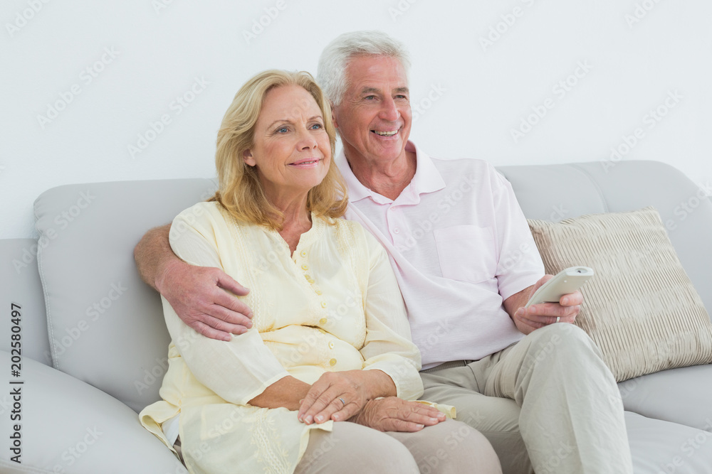 Relaxed happy senior couple with remote control Relaxed happy senior couple with remote control