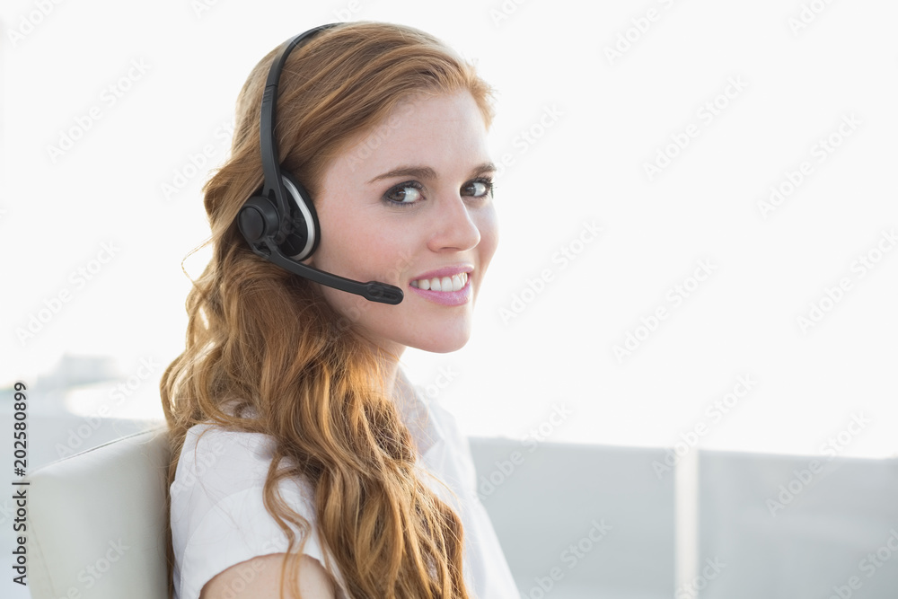 Businesswoman wearing headset in office Businesswoman wearing headset in office