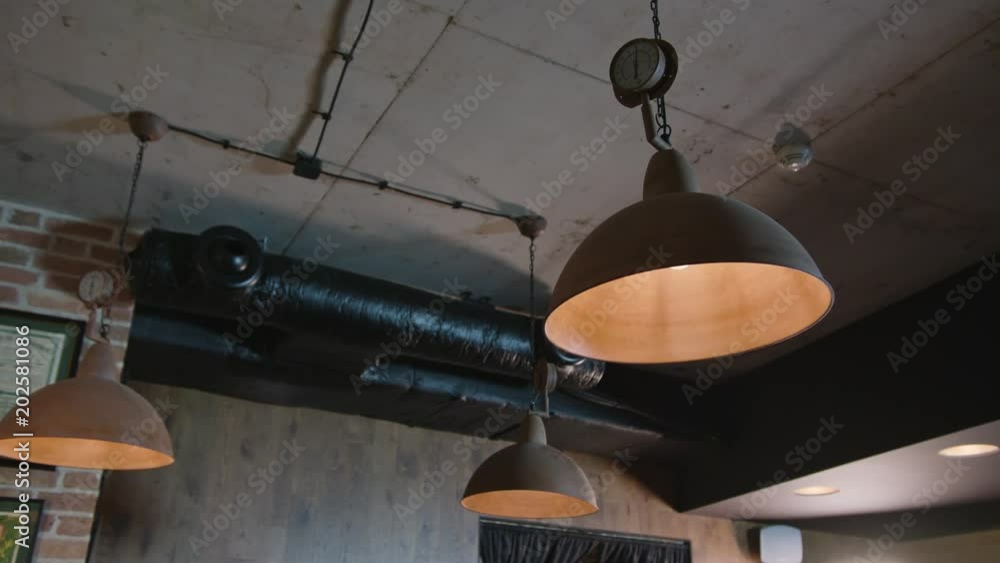 Hanging lamps with dim light in a cafe shop. Close-up shop Hanging lamps with dim light in a cafe shop. Close-up shop
