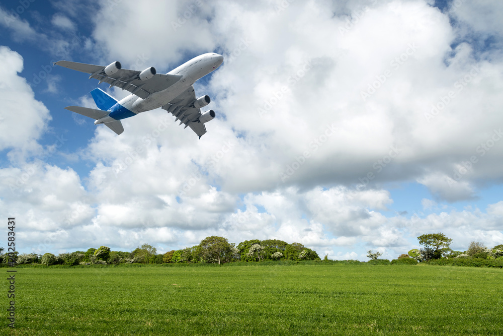 Flight of a passenger plane over the meadows Flight of a passenger plane over the meadows