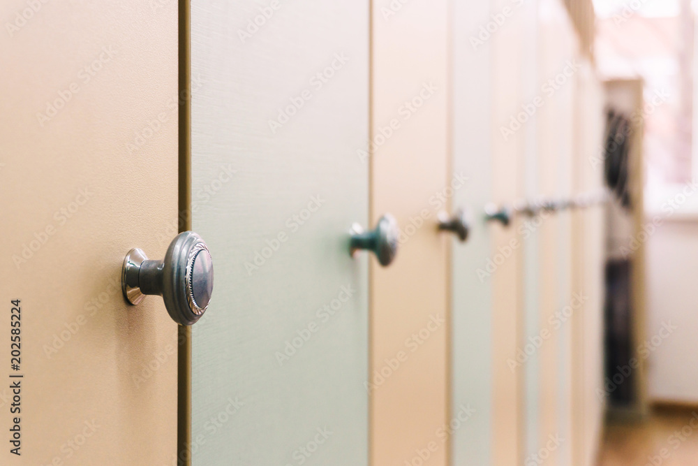 Obraz premium Wooden multi-colored lockers with handles in the school for young children
