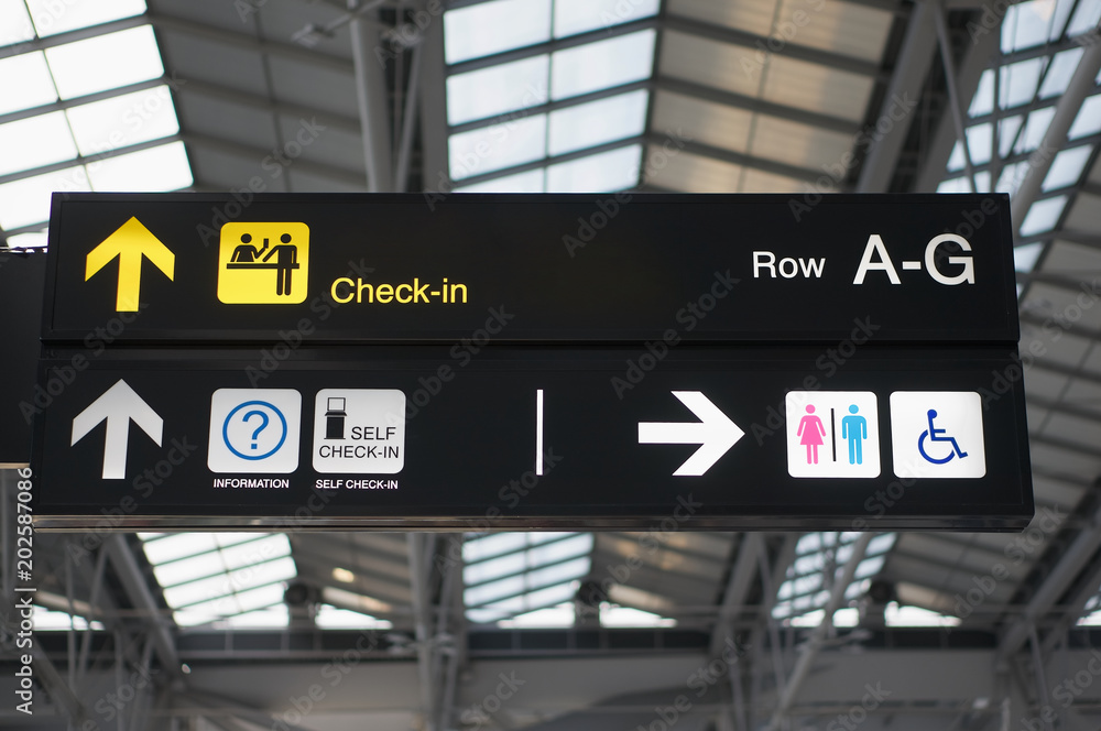 Self check-in and toilets board sign at international airport Self check-in and toilets board sign at international airport