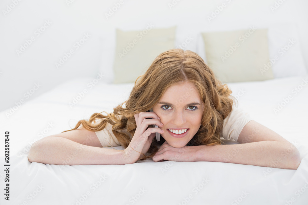 Relaxed woman using mobile phone in bed Relaxed woman using mobile phone in bed