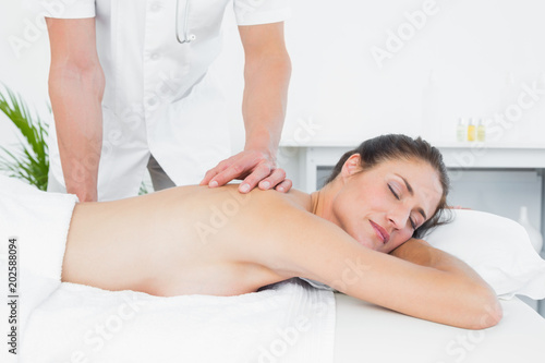 Male physiotherapist massaging womans back